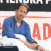 Activist Sonam Wangchuk - wearing a blue shirt - looks sideways as he sits on a hunger strike in Delhi