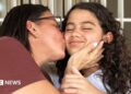 Karina (left) kisses her daughter Fabiana.