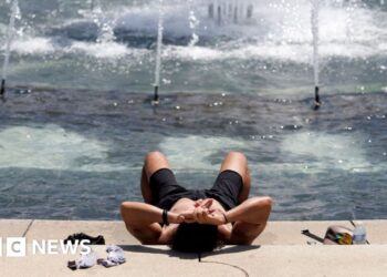 A person cools off at the World War II Memorial in Washington DC.