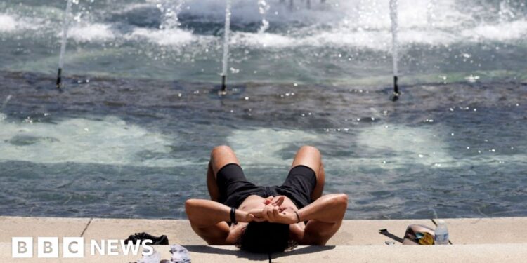A person cools off at the World War II Memorial in Washington DC.