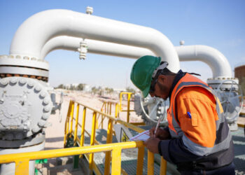 A worker checks equipment at the Rumaila oil field in Basra
