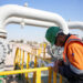 A worker checks equipment at the Rumaila oil field in Basra