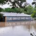 Floodwaters are seen engulfing the Rodeo Los Corrales Dance Hall in Comfort. Trees sit around the hall.