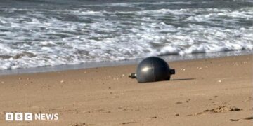 One of the six mysterious large silver spheres washed up on Forrest Beach in Queensland.