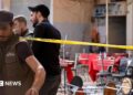 Syrian emergency services personnel work at the site a bomb blast at a cafe in central Damascus, Syria (2 July 2026)