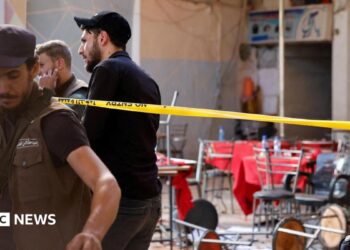 Syrian emergency services personnel work at the site a bomb blast at a cafe in central Damascus, Syria (2 July 2026)