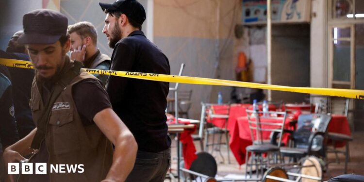 Syrian emergency services personnel work at the site a bomb blast at a cafe in central Damascus, Syria (2 July 2026)