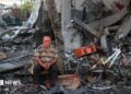 A Palestinian man rests amid debris at the site of an Israeli strike on a house in Gaza City, on July 30, 2026.