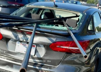 Metal pipes pierce car window