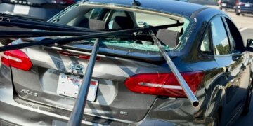 Metal pipes pierce car window