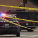San Jose police vehicles and an armored vehicle block an intersection behind police tape