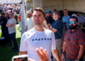 Charlie Kirk in a white T-shirt emblazoned with the word