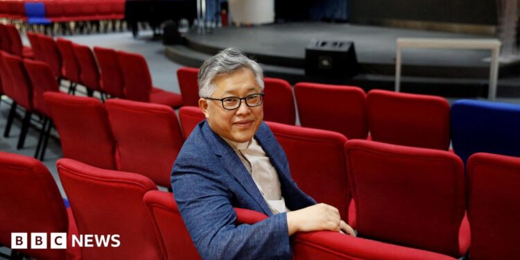 The head pastor of the Zion church in Beijing Jin Mingri poses for picures in the congregation hall of the unofficial Protestant "house" church in Beijing, China, 2018.