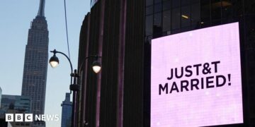 A poster of Taylor Swift  holding up a guitar outside Madison Square Garden, next to crush barriers saying "welcome to the Garden".