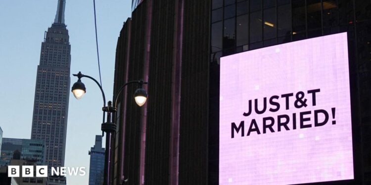 A poster of Taylor Swift  holding up a guitar outside Madison Square Garden, next to crush barriers saying "welcome to the Garden".