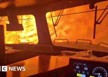 A train is surrounded by wildfire.