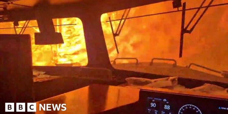 A train is surrounded by wildfire.