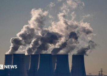 Cooling towers release water vapor at the Jaenschwalde lignite-fired power station in Jaenschwalde, Germany