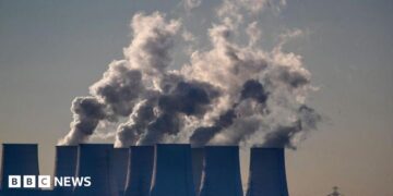 Cooling towers release water vapor at the Jaenschwalde lignite-fired power station in Jaenschwalde, Germany