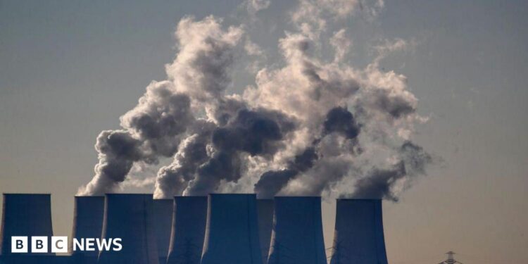 Cooling towers release water vapor at the Jaenschwalde lignite-fired power station in Jaenschwalde, Germany