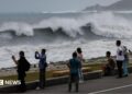 Residents observe huge waves brought by Typhoon Bavi in Hualien city, Taiwan