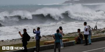 Residents observe huge waves brought by Typhoon Bavi in Hualien city, Taiwan