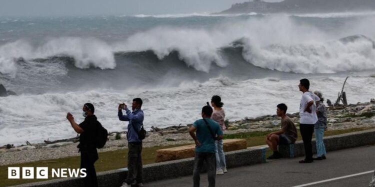 Residents observe huge waves brought by Typhoon Bavi in Hualien city, Taiwan