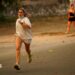 A person runs as the fire spreads in the mountains of Navaluenga, Avila, Spain