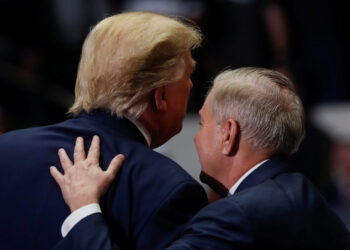 U.S. Senator for South Carolina Lindsey Graham speaks with U.S. President Donald Trump during his campaign rally in Charlotte