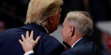 U.S. Senator for South Carolina Lindsey Graham speaks with U.S. President Donald Trump during his campaign rally in Charlotte