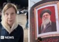 On the left, Lyse Doucet wear a dark jacket. On the right, an image of Iran's former supreme leader.