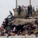 Spanish soldiers stand guard and intervene as migrants arrived swimming to Spanish territory of Ceuta on May 18, 2021