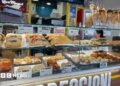 Food stall in Napoli with shelves stocked with sandwiches, pasta, bread, and fried foods