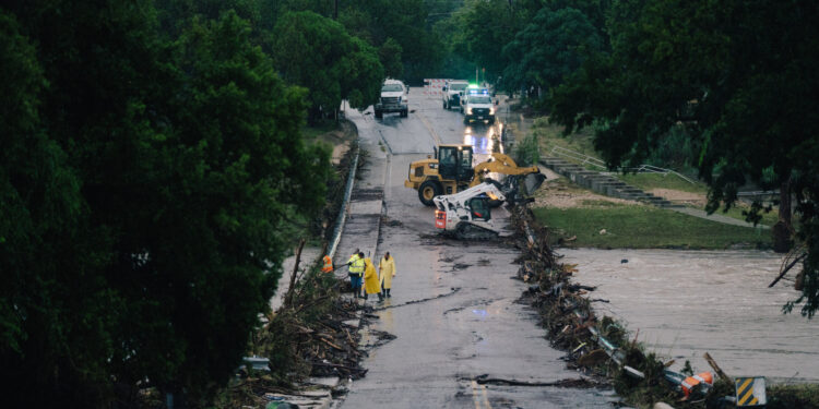 First responders on a bridge covered by water after the flood in Kerrville on July 16, 2026.