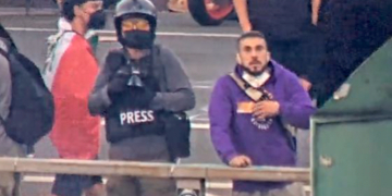Ismael Vega stands on the Main Street freeway overpass during anti-ICE riots in Los Angeles, according to federal prosecutors