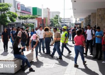 People pictured in a street in San Salvador, El Salvador's capital, following an evacuation