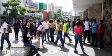 People pictured in a street in San Salvador, El Salvador's capital, following an evacuation