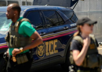 ICE agents secure the entrance to Delaney Hall detention center as demonstrators remain gathered in Newark