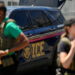 ICE agents secure the entrance to Delaney Hall detention center as demonstrators remain gathered in Newark
