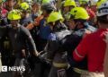 Group of rescuers holding man on stretcher