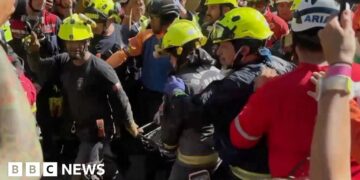 Group of rescuers holding man on stretcher