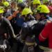 Group of rescuers holding man on stretcher