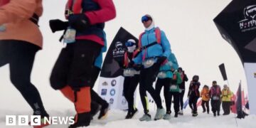 Runners set off from the snowy starting line in full thermal gear and goggles