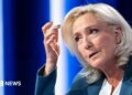 President of Rassemblement National parliamentary group Marine Le Pen poses poses ahead of a television interview entitled "Le Grand Entretien" broadcast on French news channel LCI, in Boulogne-Billancourt, southern of Paris on July 1, 2026
