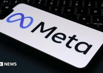 The Meta logo is displayed on a mobile phone