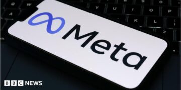 The Meta logo is displayed on a mobile phone