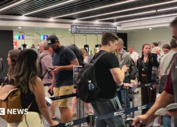 People move through the queue for the Entry Exit System process at Fuimicino Airport in Rome, Italy.