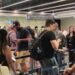 People move through the queue for the Entry Exit System process at Fuimicino Airport in Rome, Italy.
