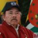 President of Nicaragua Daniel Ortega looks on during the opening event of the XXIII Summit of the Bolivarian Alliance for the Americasin Caracas, Venezuela, in 2024. He is wearing a red jacket and a baseball cap with the Nicaraguan flag emblazoned on it. He has a moustache.