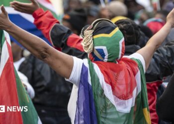 Protesters draped in South African flags in a rally against undocumented immigrants during a nationwide anti-immigration shutdown in Cape Town, South Africa, 30 June 2026.